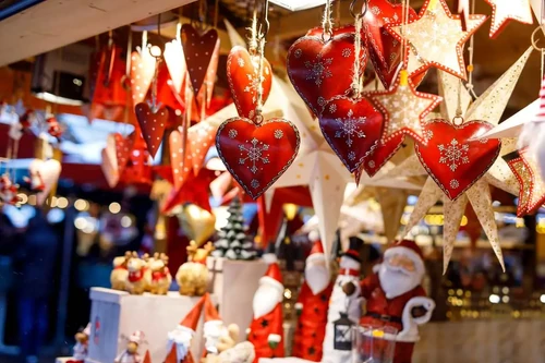 A hanging array of Christmas ornaments at a seasonal market.