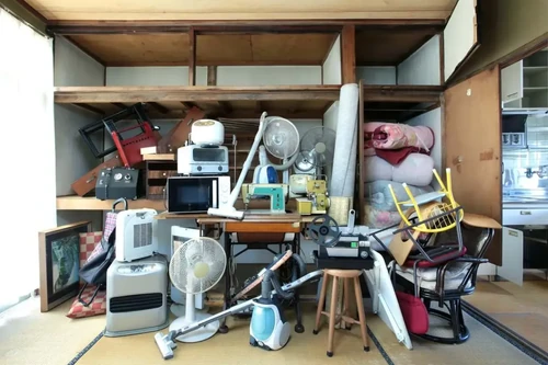 Multiple items that could be stored in a storage unit sitting in the back of a garage.